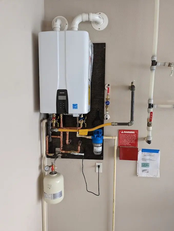 Professional plumber installing copper piping in a North Bergen home